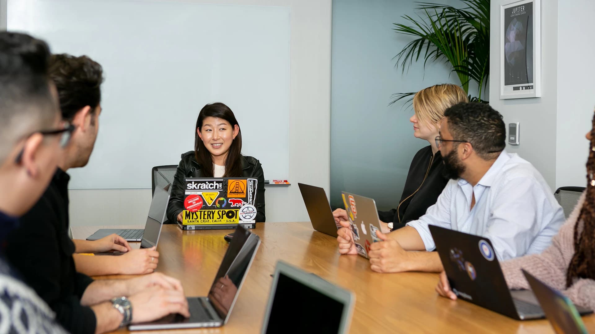 Business consultants exchanging ideas around a meeting table